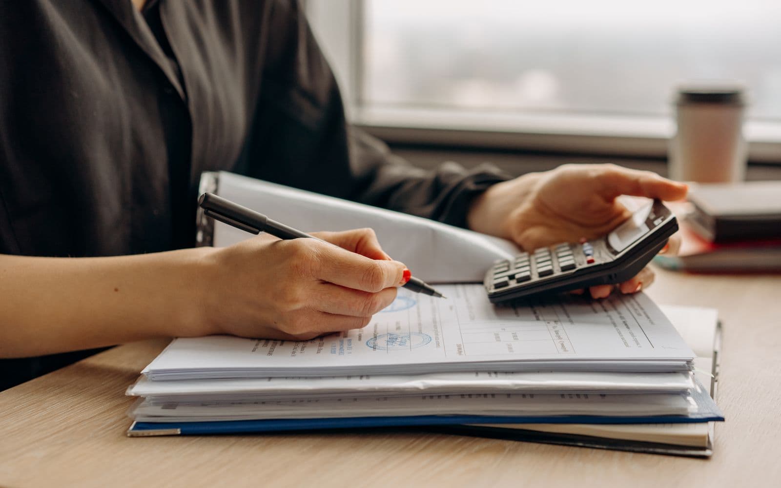 Financial documents and a calculator on a desk for reviewing a credit report